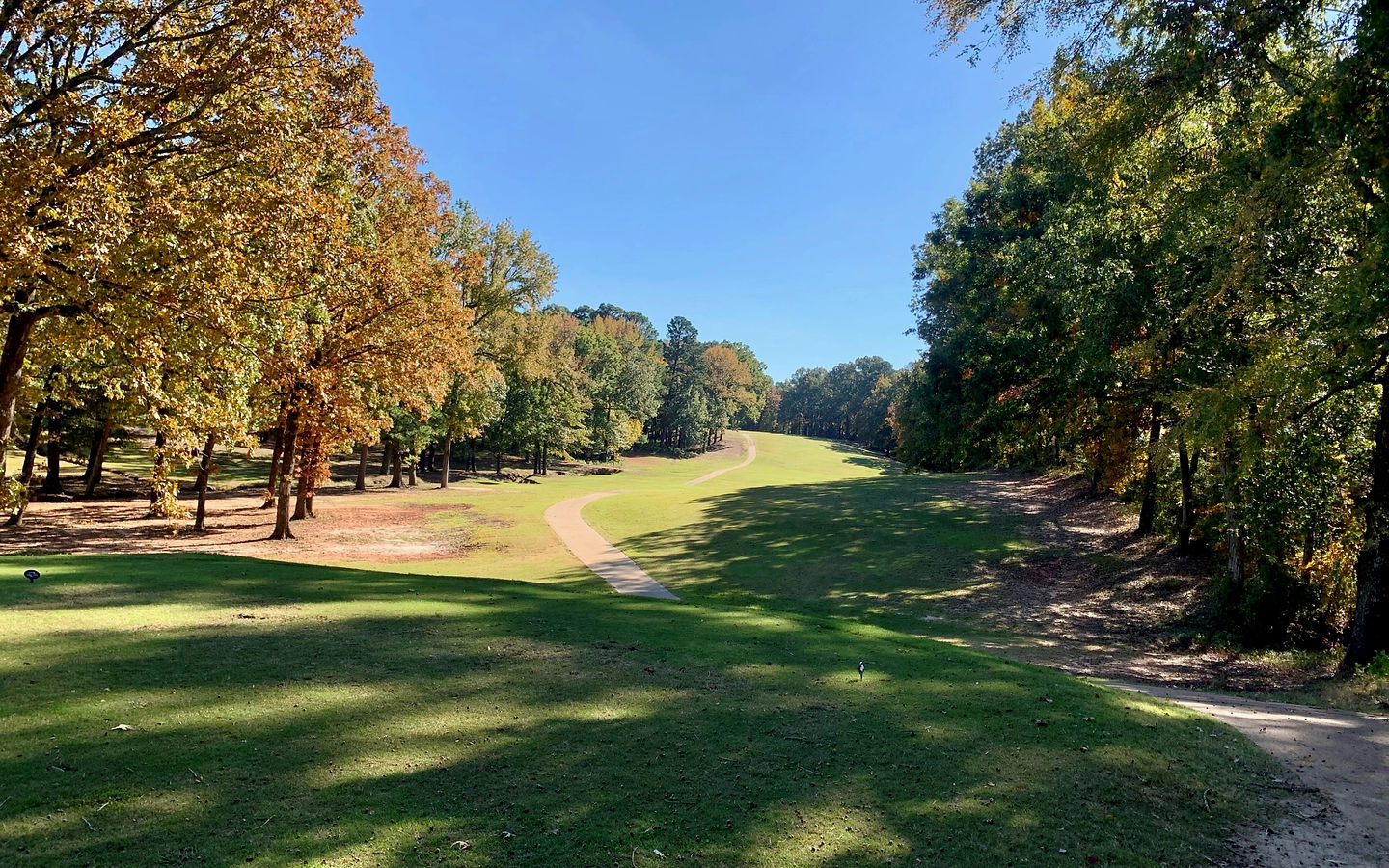 Northridge Country Club fairway lined with tall pines and hardwoods